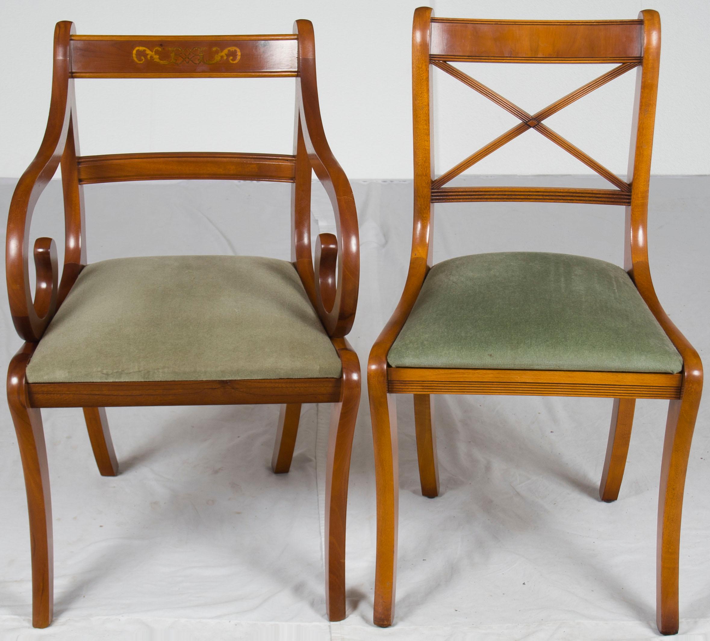 Here we have a lovely set of six Regency style dining room chairs consisting of four side chairs and two arm chairs. This set was made in England around the year 1960 of gorgeous yew wood. They epitomize Regency chairs with their sabre shaped back