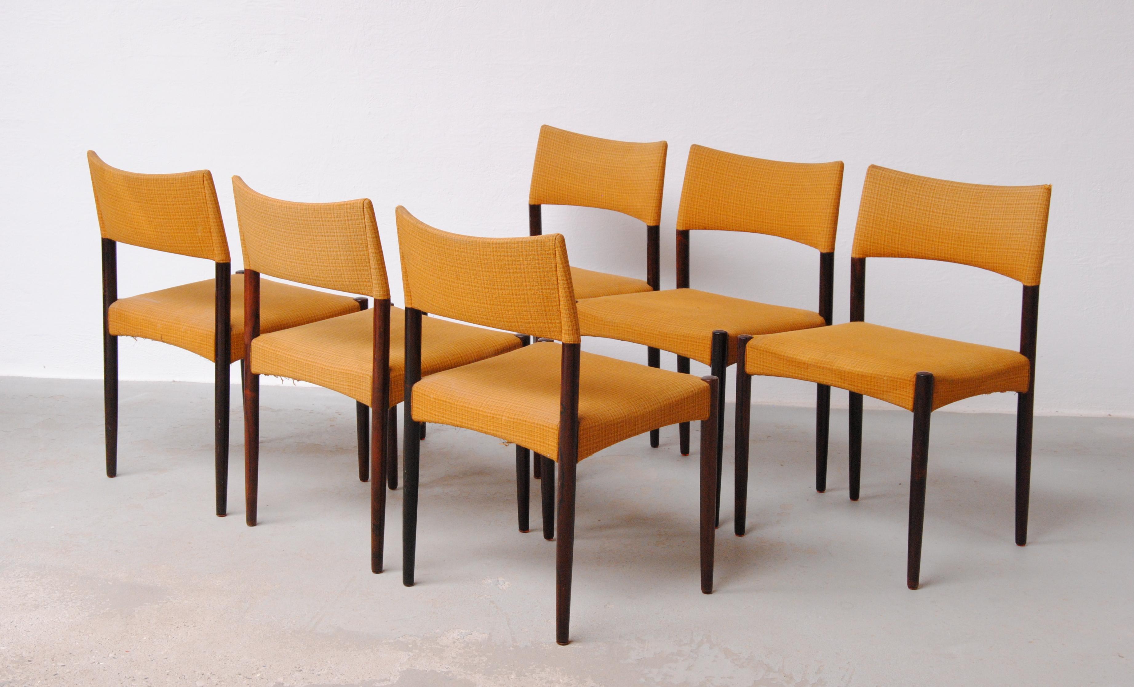 Set of Six Restored Rosewood Ejnar Larsen and Axel Bender Madsen Dining Chairs by Willy Beck

The dining chairs feature a modest yet sophisticated design with their squared seat and what at first appeares as straight lined design that at a closer