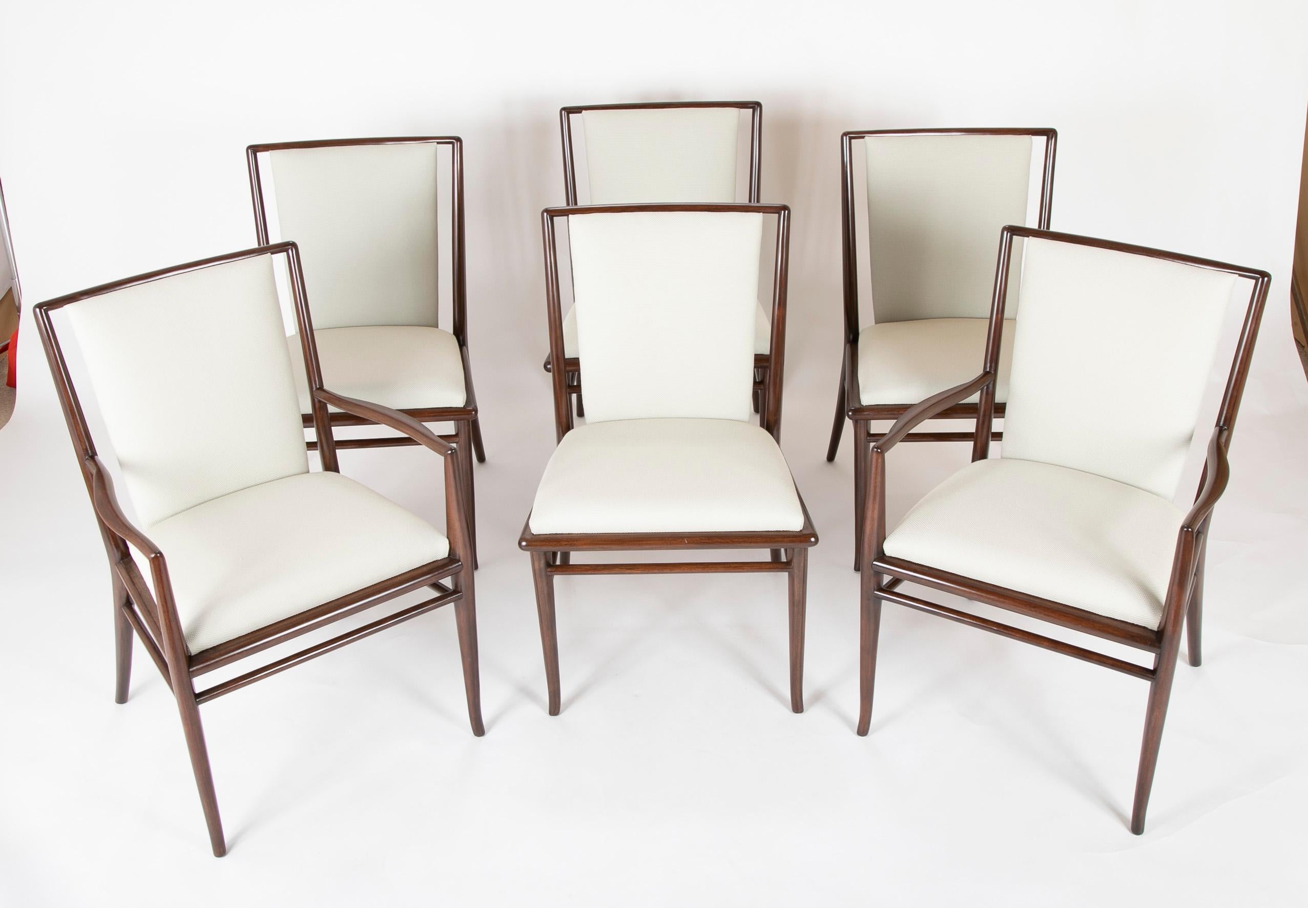 Set of six Robsjohn-Gibbings dining chairs in dark walnut stain; two arms and four sides, circa late 1950s-early 1960s. Newly upholstered in Delany and long fabric. Seat height 19