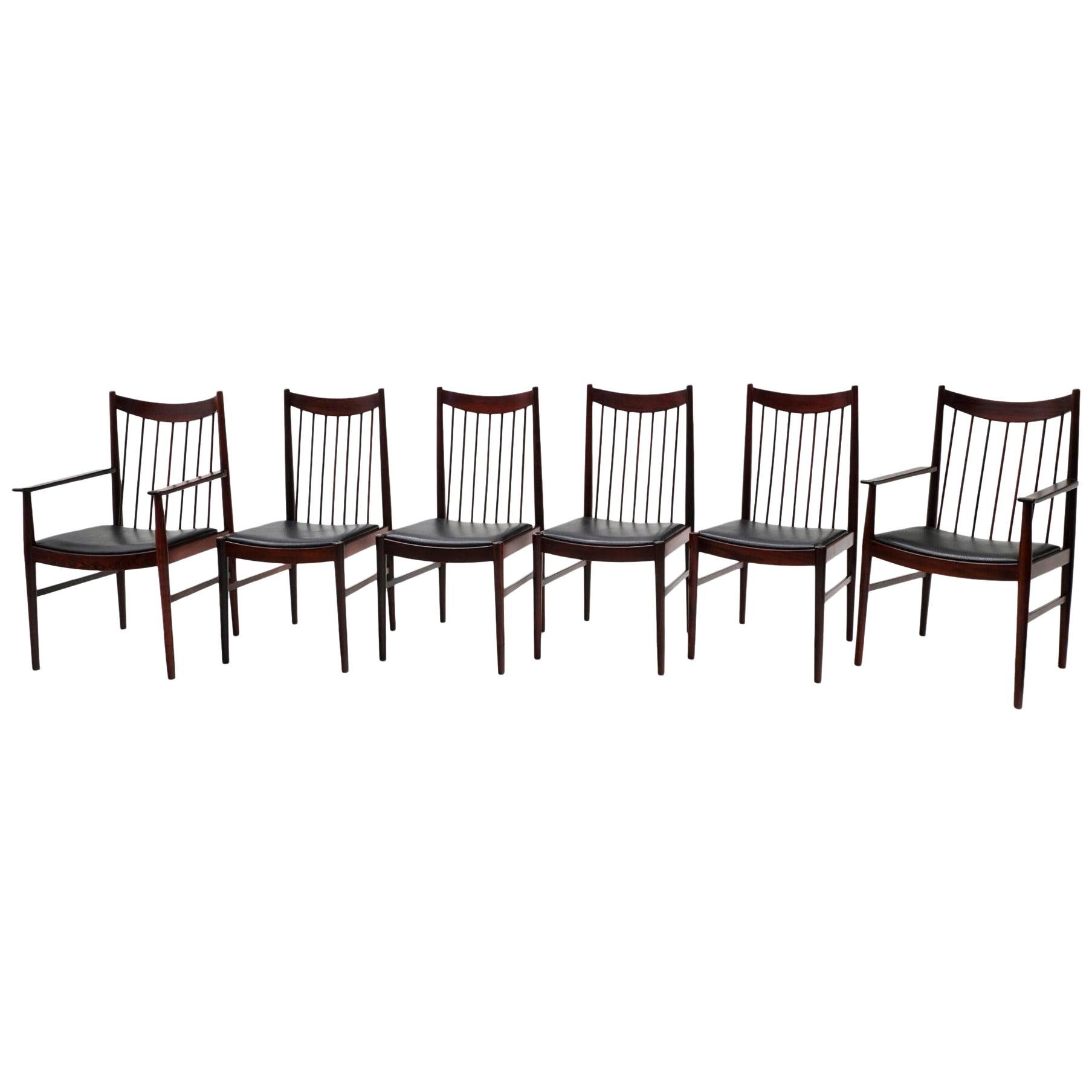 Set of 6 high back Danish modern rosewood dining chairs designed by Arne Vodder for Sibast. Expertly refinished. Original black vinyl seat covering. Two armchairs and six side chairs.

Captain chair dimensions
21.75 in. D x 21.75 in. W x 38.5