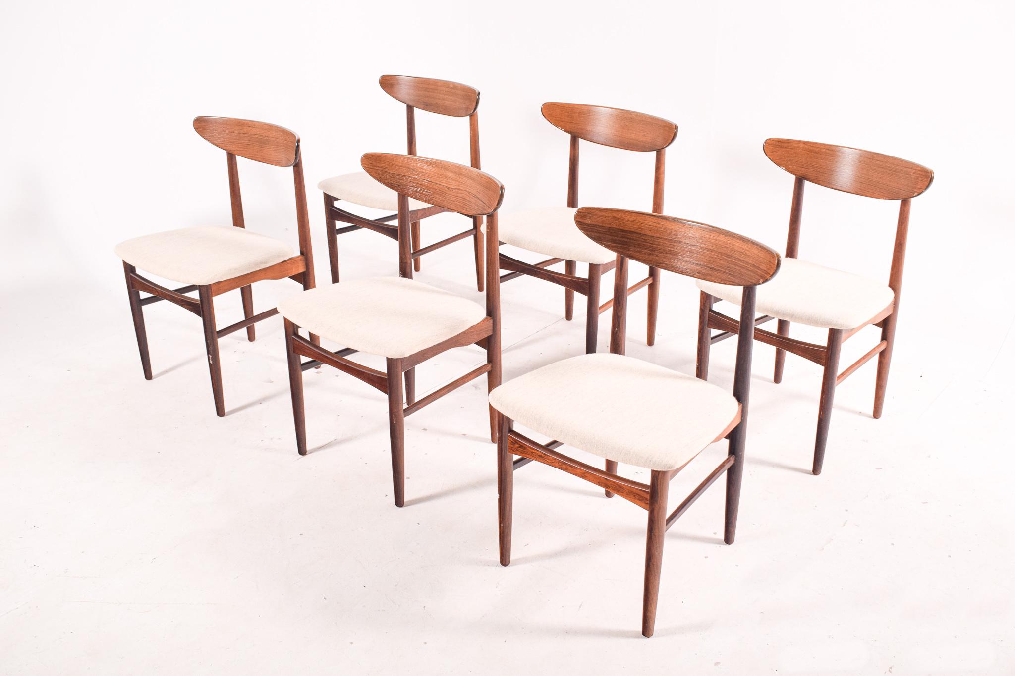A nice set of six Mid-Century Modern solid rosewood dining chairs by well known Danish manufacturer AS Skovby Møbelfabrik and EW Bach designer. These are almost identical to the Harry Ostergaard dining chairs and they are excellent quality. Marked