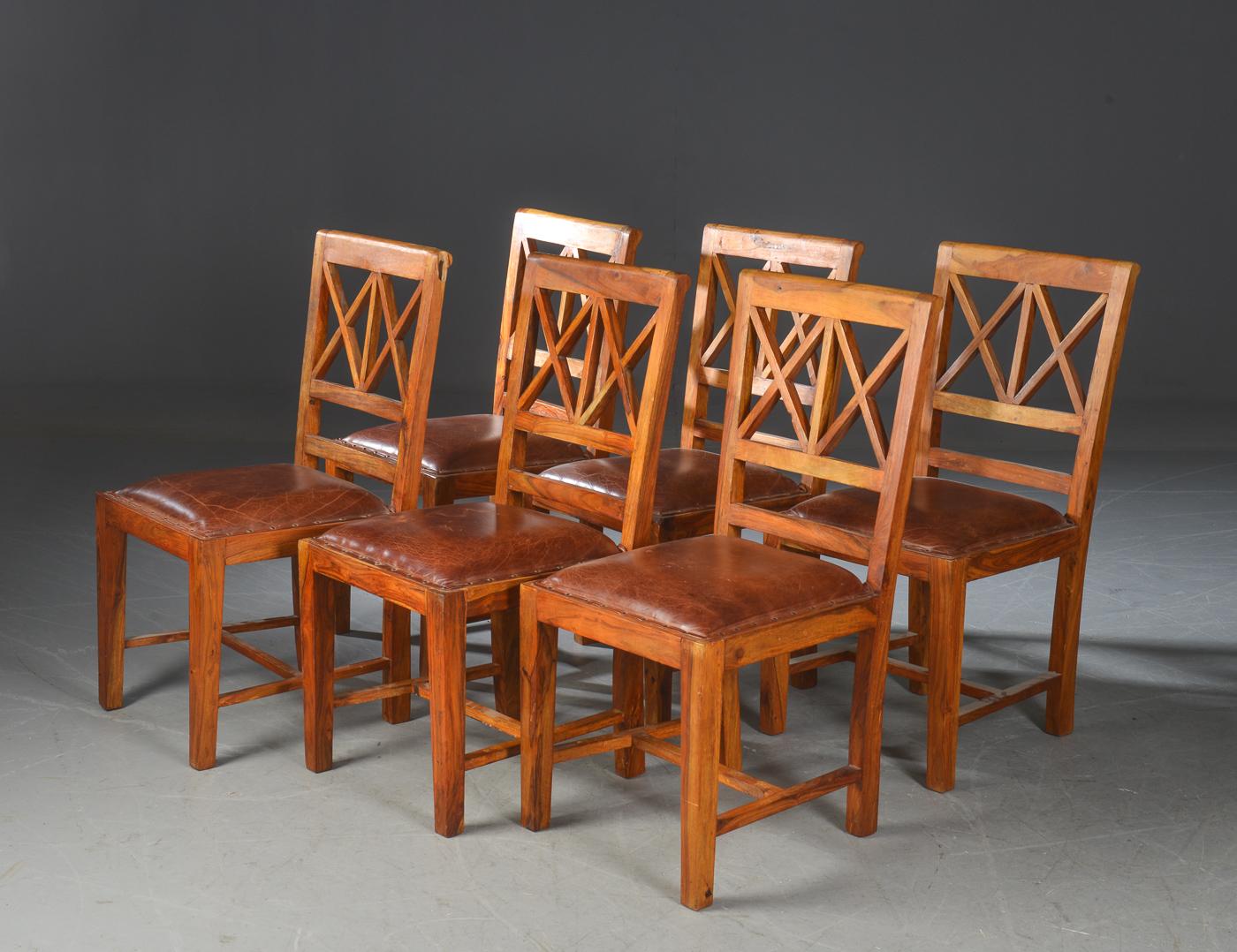 Nice set of Scandinavian rustic dining chairs, (6) in hardwood. Cognac color, patinated leather seat studded nailheads. Traces of wear to leather. $3800 for set of 6.