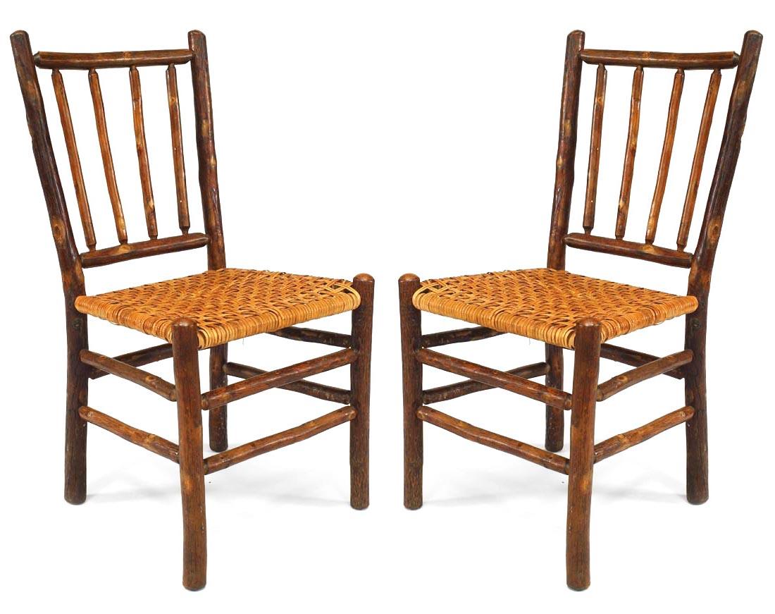 Set of 6 Rustic Old Hickory side chairs with a 4-spindle back & rattan seat with legs joined by a stretcher. (c. 1935 metal tag: Genuine Old Hickory Bruce Preserve, Martinsville Ind.)
