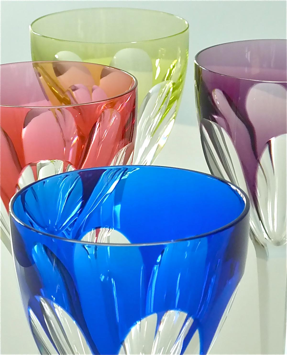 Exclusive set of six gorgeous and fine hand-cut crystal wine glasses in colors light ocean-blue and dark vibrant blue, light yellow-green and green, violet and red made by Saint Louis France around 1960-70. Saint Louis France which is the oldest