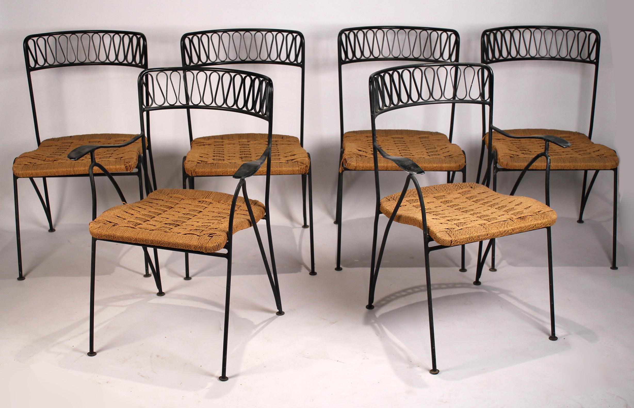 Beautiful set of six Salterini chairs designed by Maurizio Tempestini for Salterini made in Italy. The set is comprised of two-arm and four side chairs with the original paper cord seats. All are in good original condition, some retain the hanging