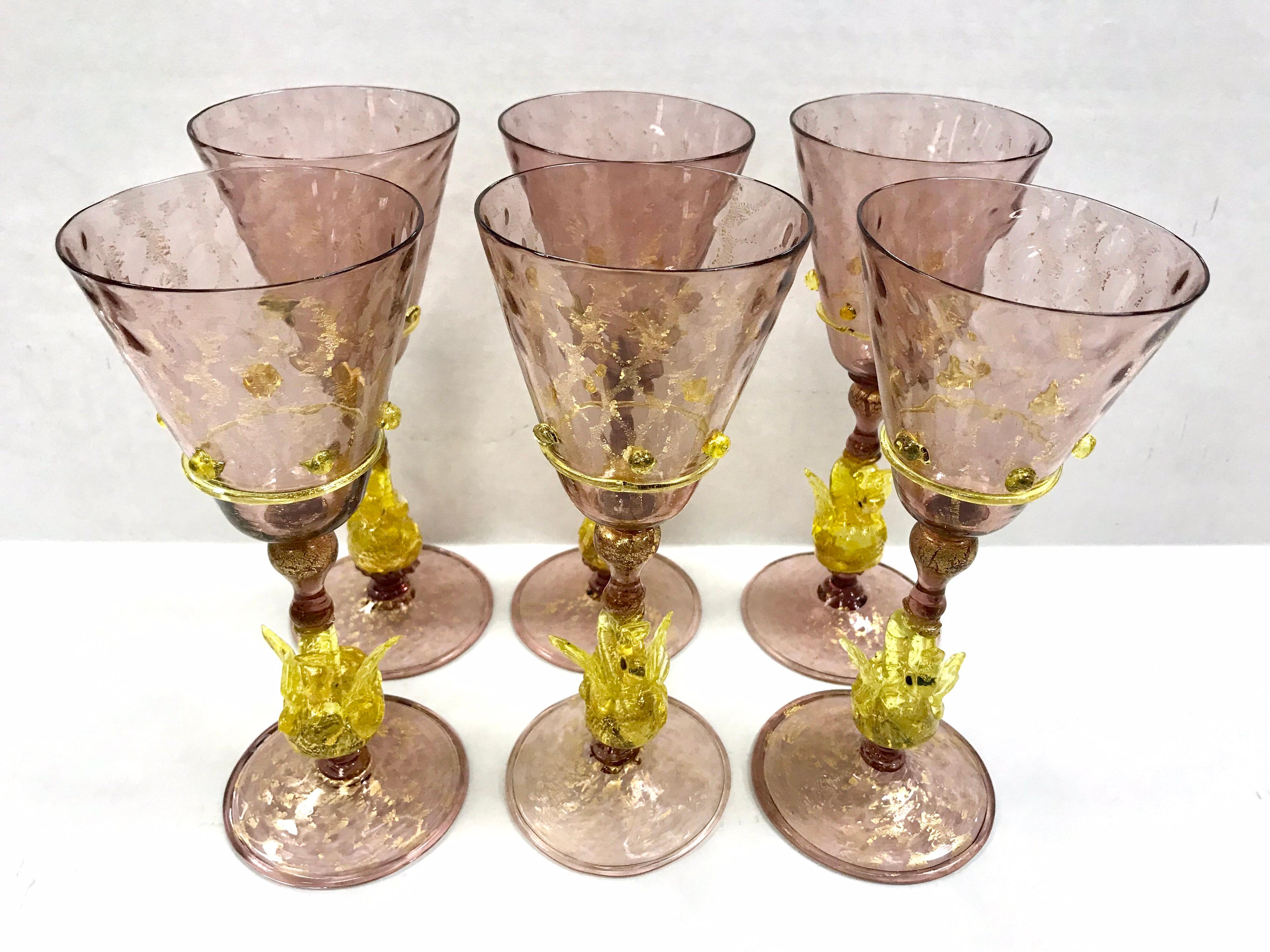 This is a rare set of six, hand blown Venetian stemware glasses made by Salviati, circa 1920s. The set appear to be wine glasses and are spectacular. They feature a figural golden yellow swan connector and applied applique. The color is a soft