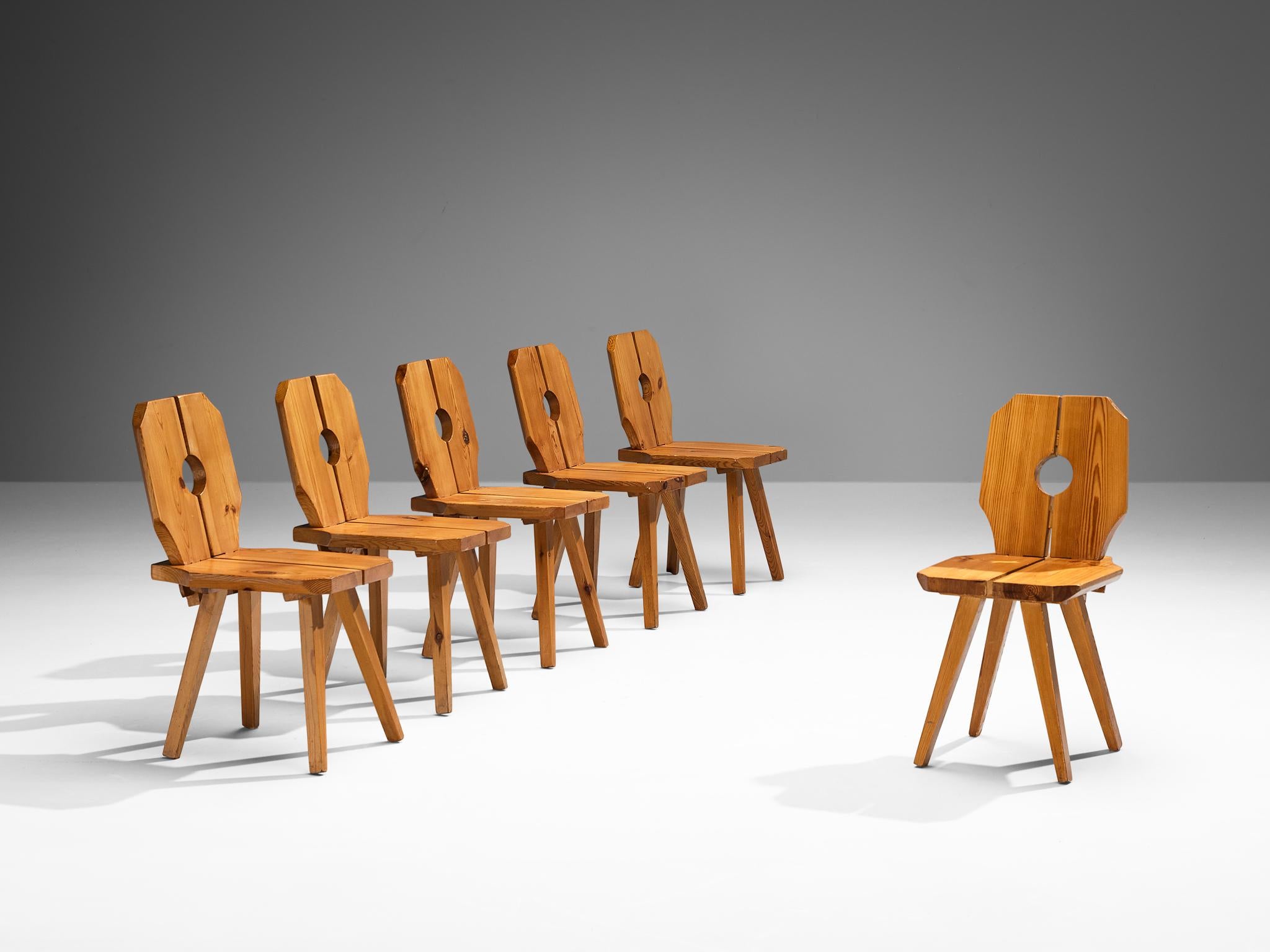 Set of six dining chairs, solid pine, Europe, 1960s

Sculpted dining chairs in expressively grained pine. Multiple features characterize the sculpted look of this set of twelve chairs. Firstly, the polygonal shaped backrest and seat that are parted
