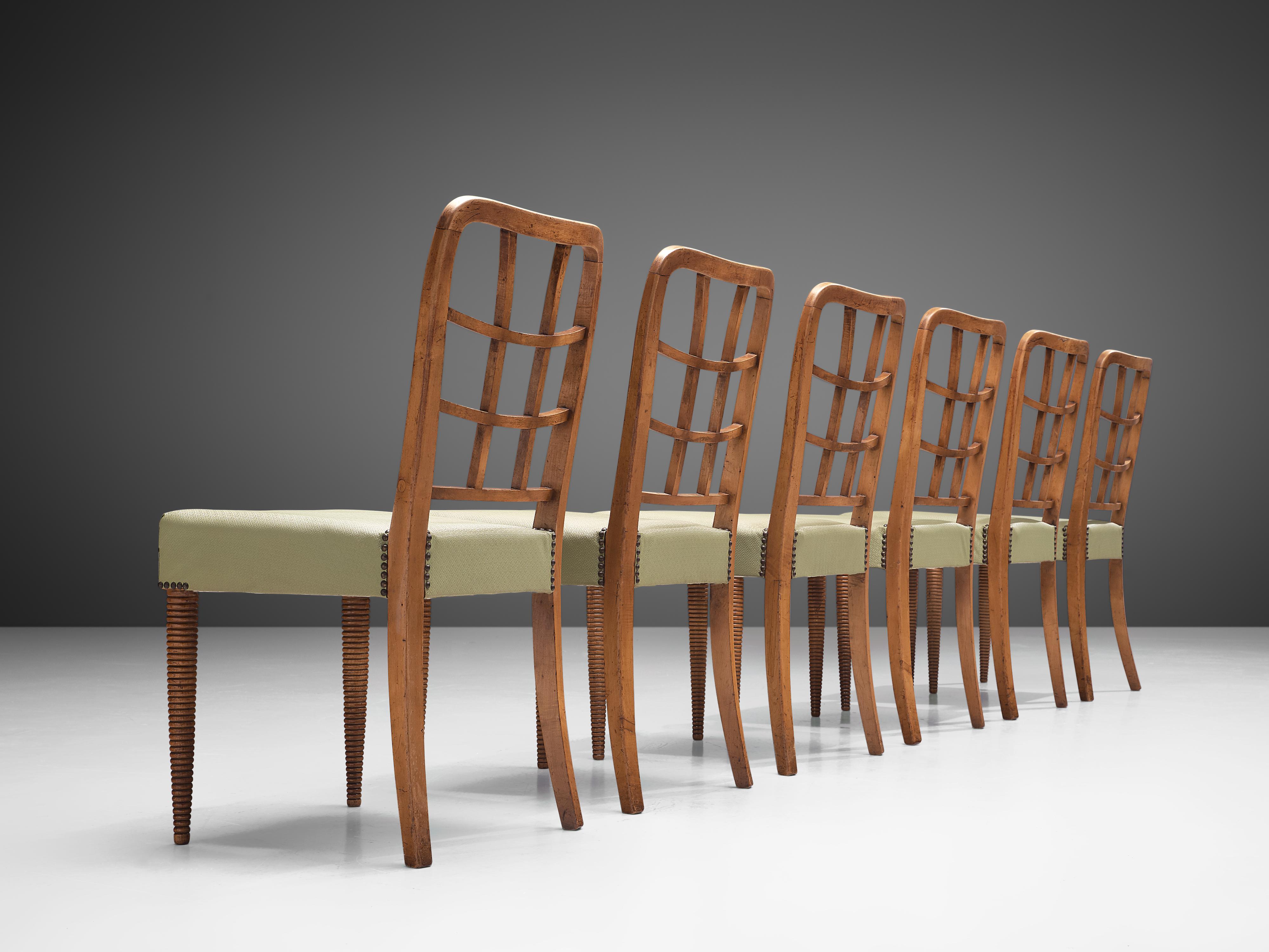Set of six dining chairs, beech, leatherette, Italy, 1950s

This set of dining chairs is both sculptural and well-constructed. The elegant back shows an open frame with a grid that follows the tapered lines of the backrest. The front legs have a