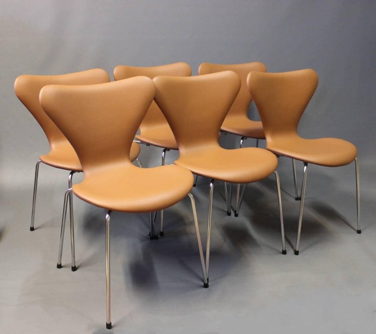 A set of six chairs, model 3107, designed by Arne Jacobsen in 1955 and manufactured by Fritz Hansen. The chairs have recently been upholstered in classic cognac colored leather.