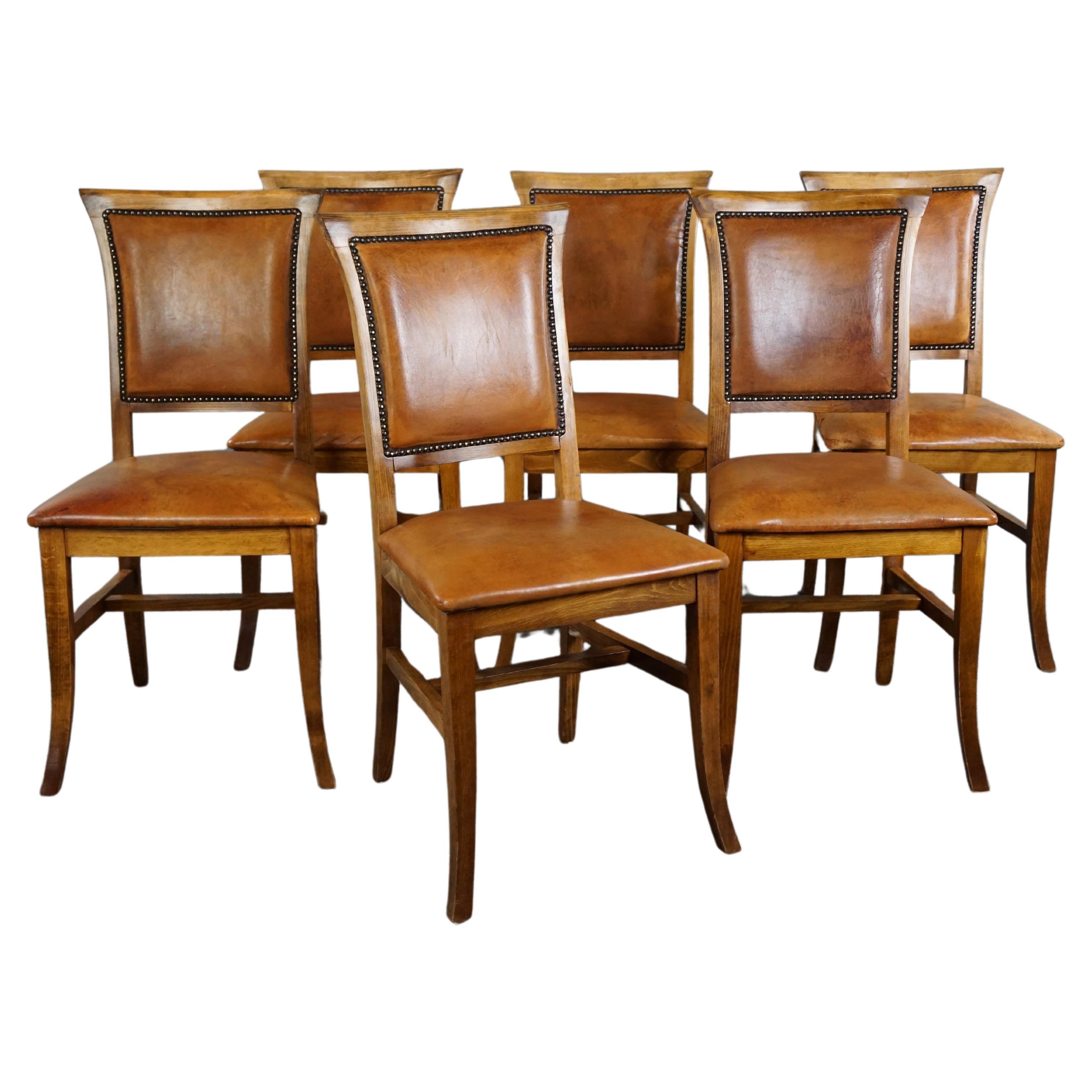 Set of six sheep leather dining chairs with a light wooden frame For Sale