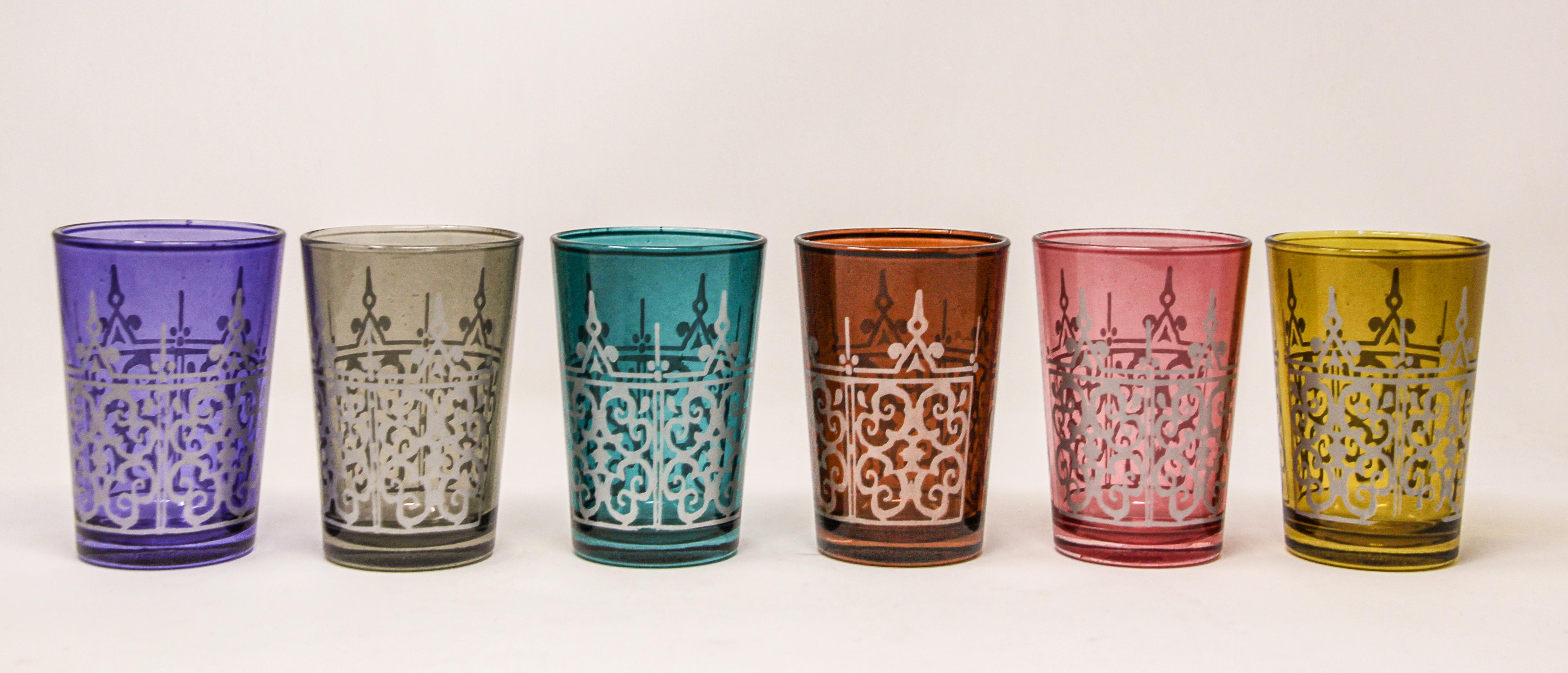 Set of six shot colored glasses with raised Moorish design.
Decorated with a classical pattern Moorish frieze.
One red, one purple, one orange, one blue, one violet, one grey.
Use these elegant glasses for Moroccan tea, or any hot or shot cold