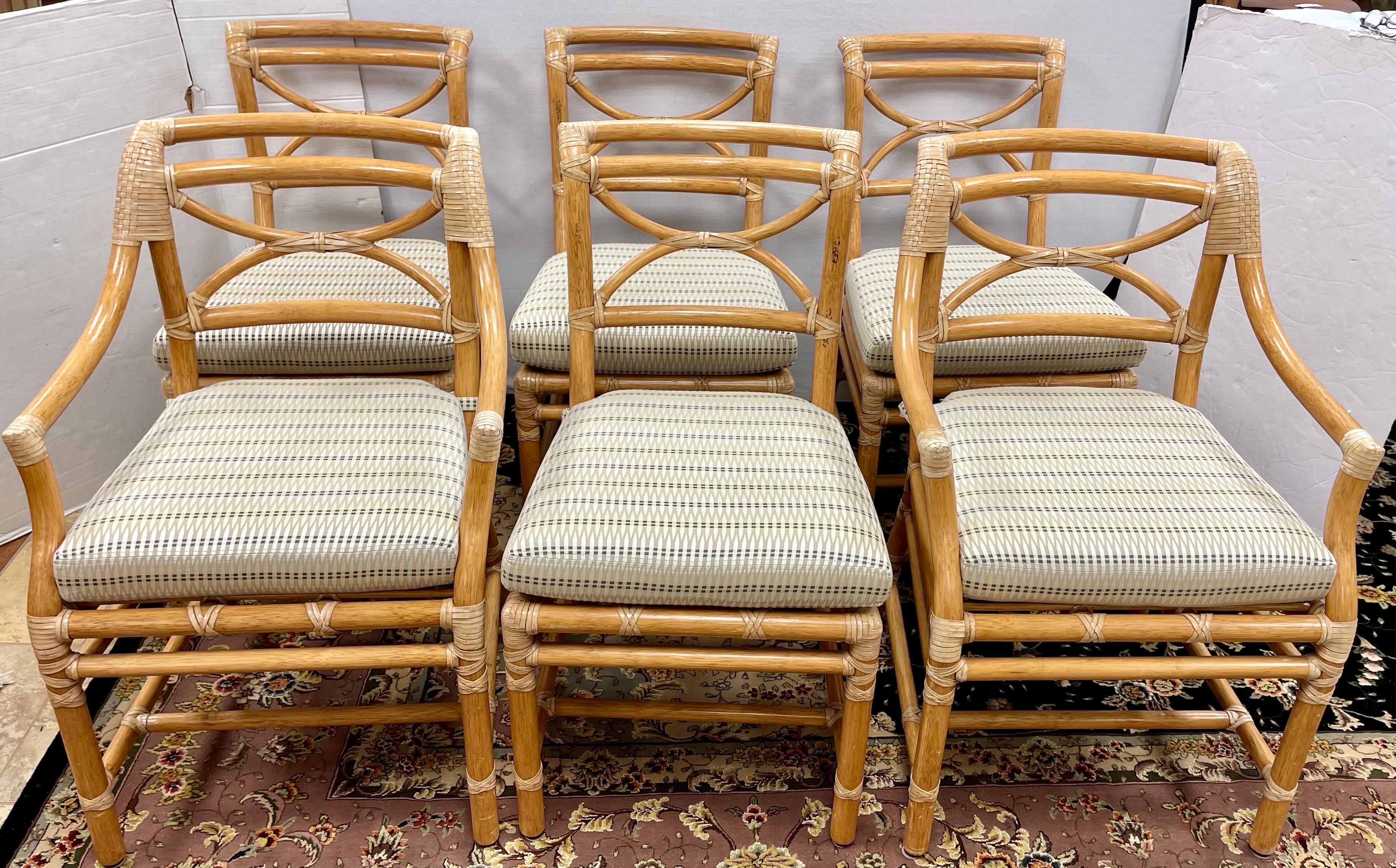 Magnificent set of six McGuire rattan dining chairs designed by Elinor McGuire. The set consists of two armchairs or host chairs and four side chairs in great condition. The chairs have an abundance of leather rawhide laces on the exposed joints.