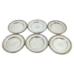 Set of six silver bread plates with embossed friezes