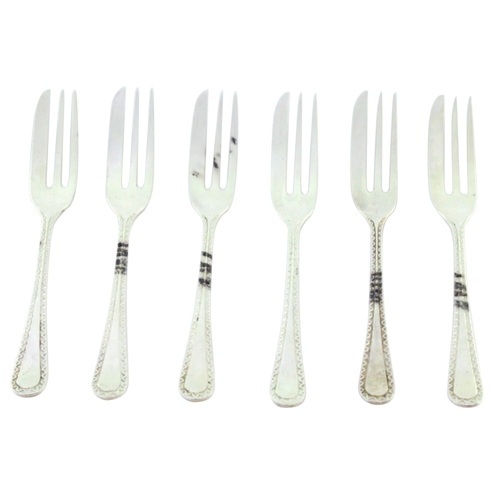Set of six silver cake forks with grooves along the handles
