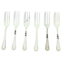 Set of six silver cake forks with grooves along the handles