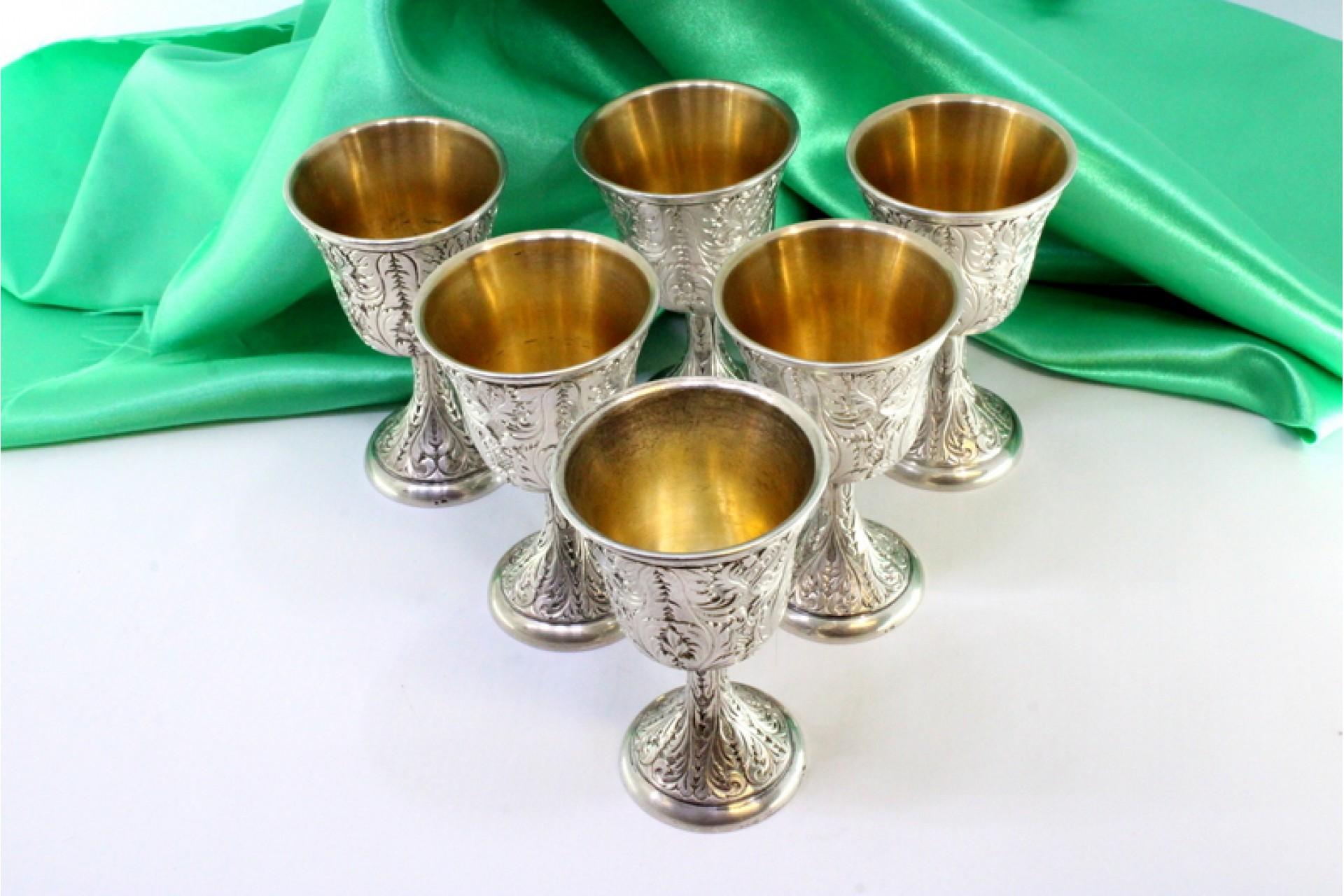 Set of six silver chalices with chiseled reliefs and gold interior For ...