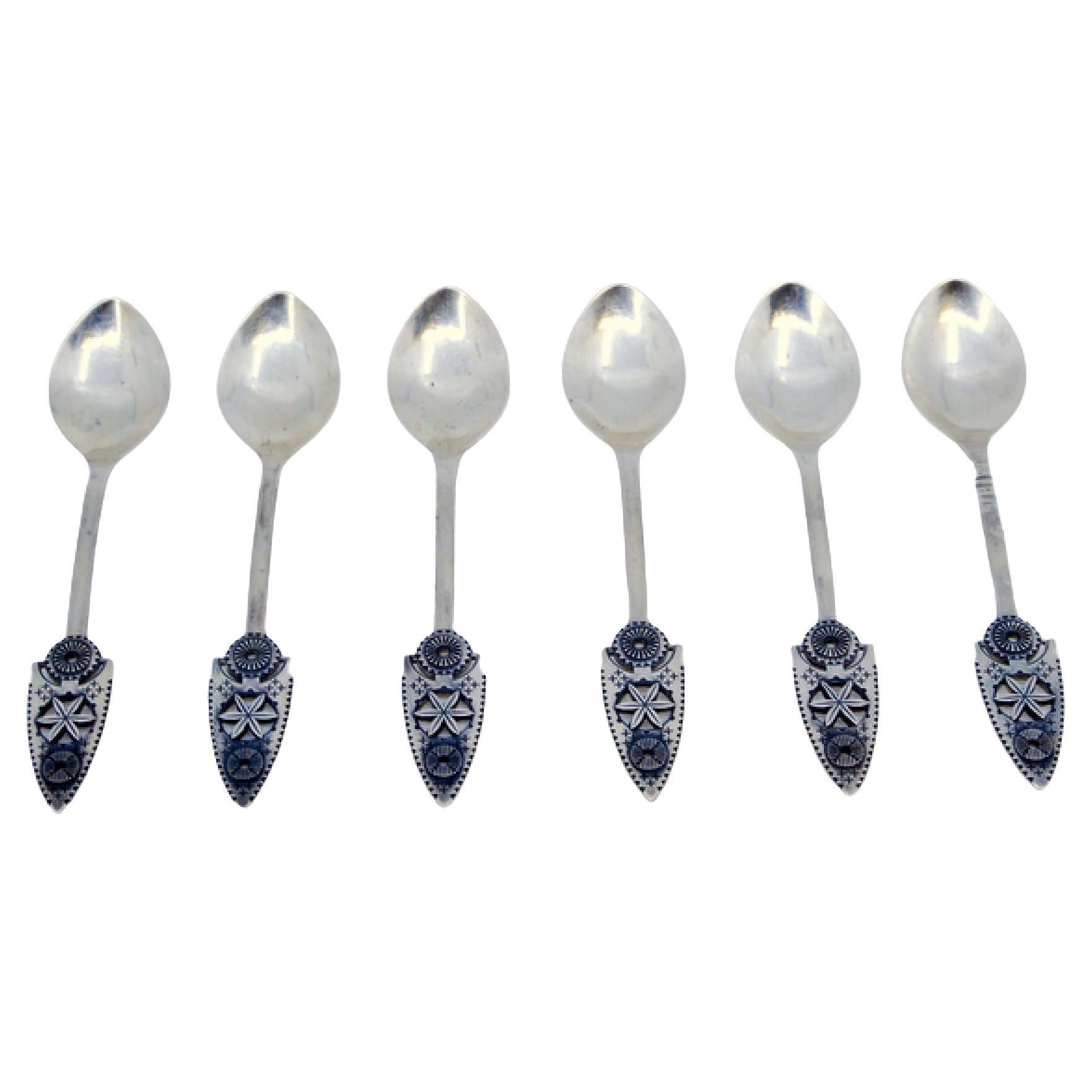 Set of six silver dessert spoons with applications and reliefs on the handles