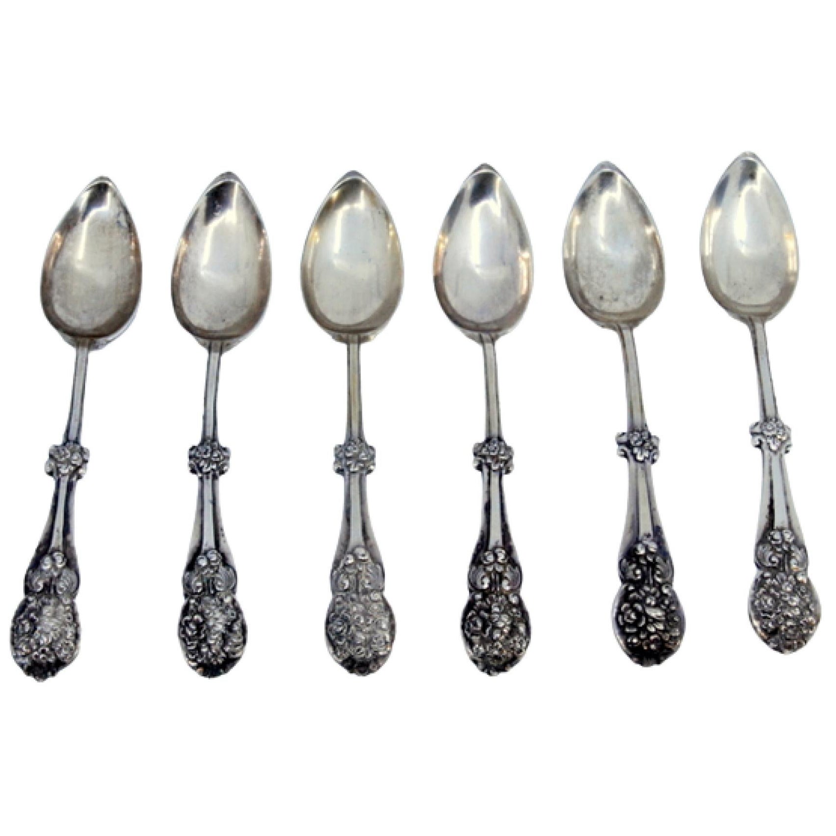 Set of six silver dessert spoons with trim and shells on the handle