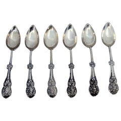 Set of six silver dessert spoons with trim and shells on the handle