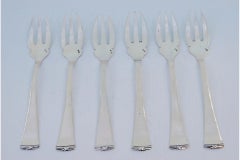 Set of six silver oyster forks with grooved handles