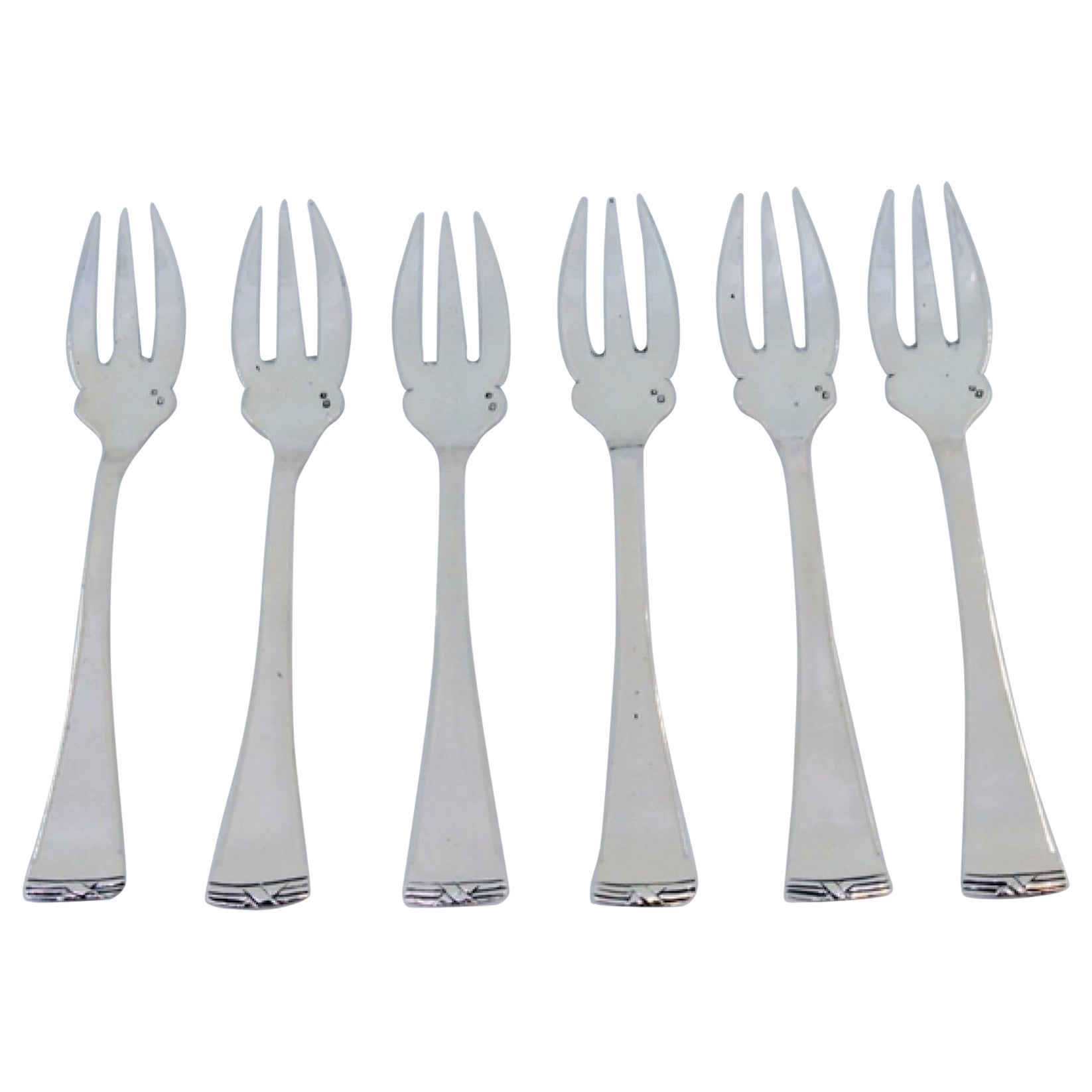 Set of six silver oyster forks with grooved handles