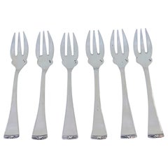 Set of six silver oyster forks with grooved handles