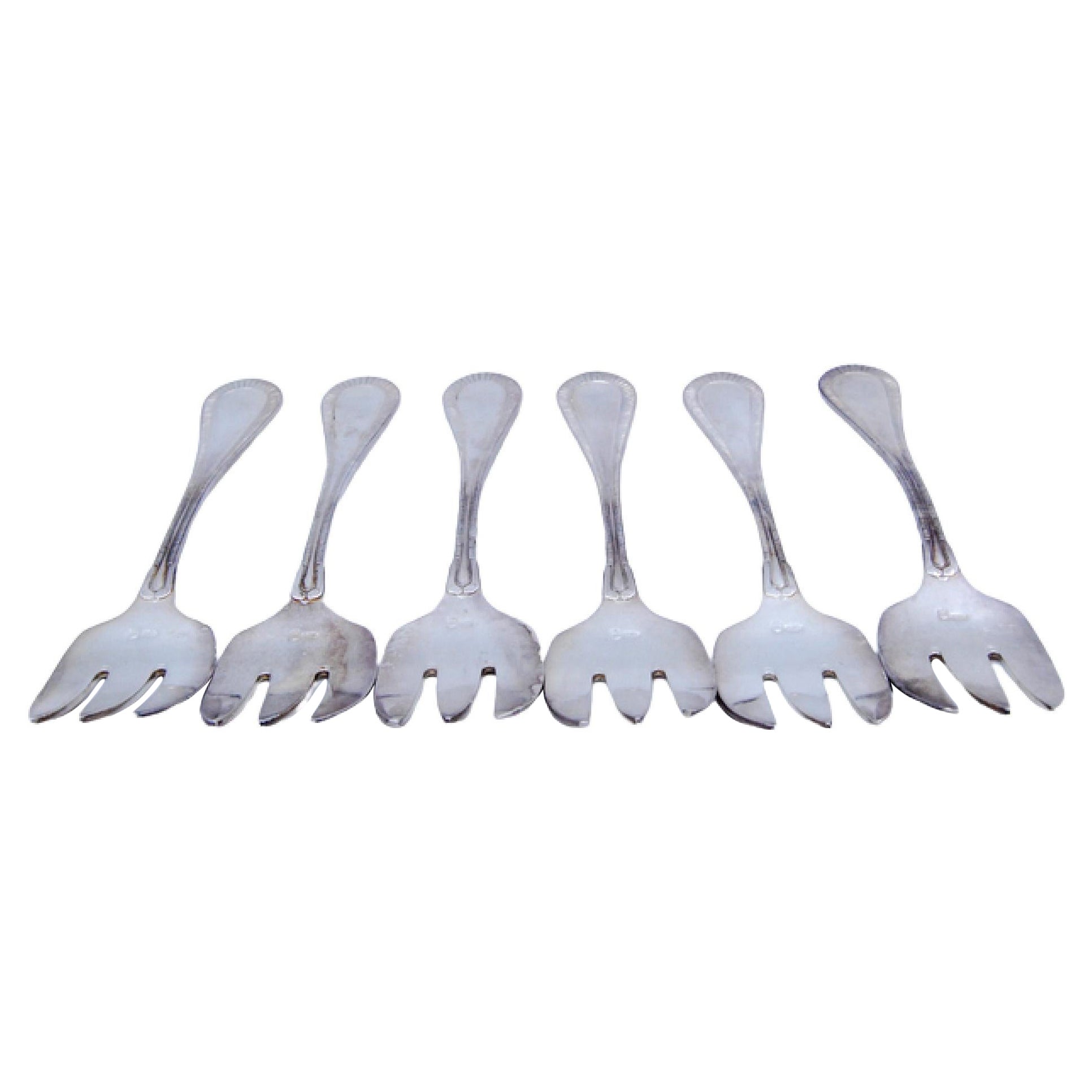 Set of six silver oyster forks with grooves along the handles