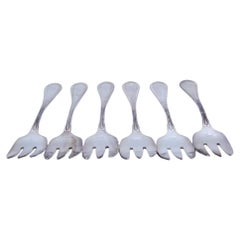 Set of six silver oyster forks with grooves along the handles