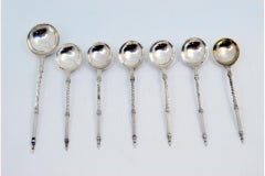 Set of six silver teaspoons and sugar ladles with twisted and raised handles