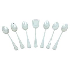 Set of six silver teaspoons and sugar scoops with trim around the handles