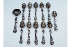 Set of six silver teaspoons and sugar shovel with embossed leaves