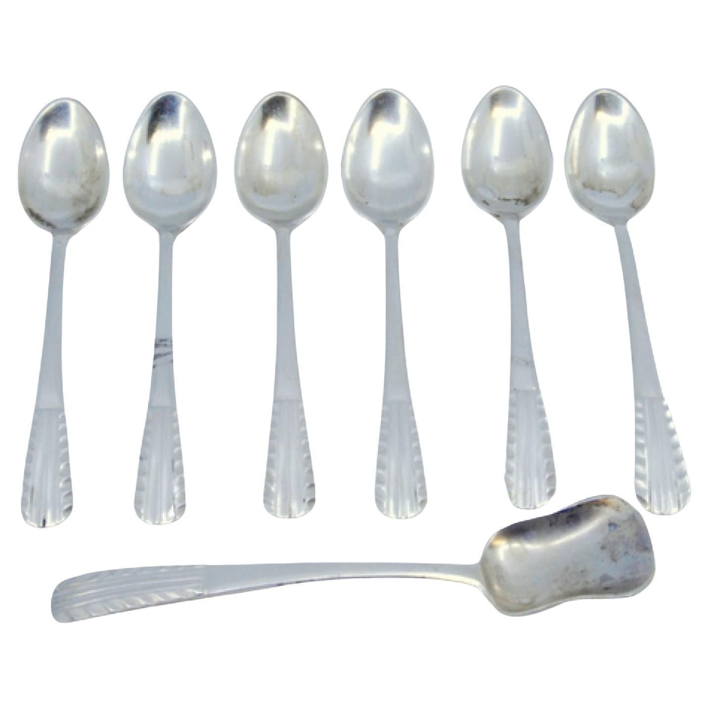 Set of six silver teaspoons and sugar shovel with raised handles For Sale