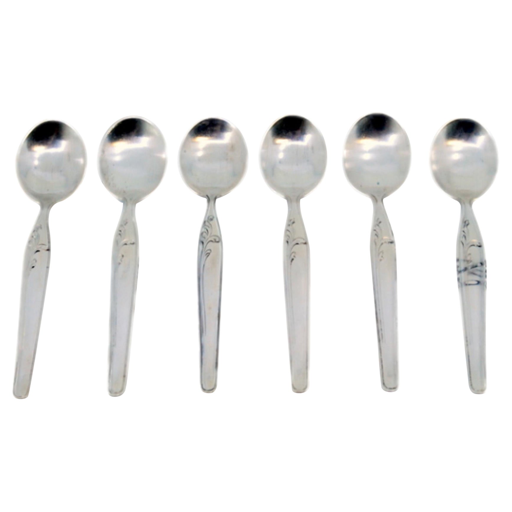 Set of six silver teaspoons with floral motifs and trim on the handles