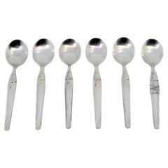 Set of six silver teaspoons with floral motifs and trim on the handles