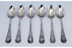 Set of six silver teaspoons with raised scrolls on the handles