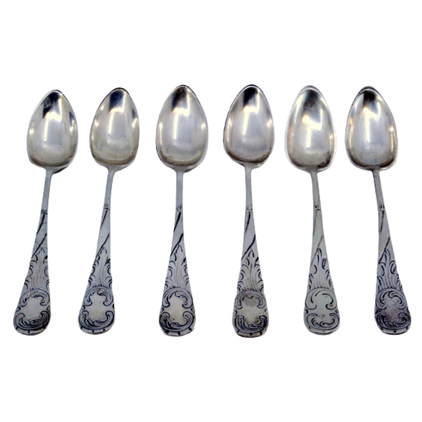 Set of six silver teaspoons with raised scrolls on the handles