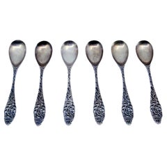 Set of six silver teaspoons with reliefs and cut-out handles