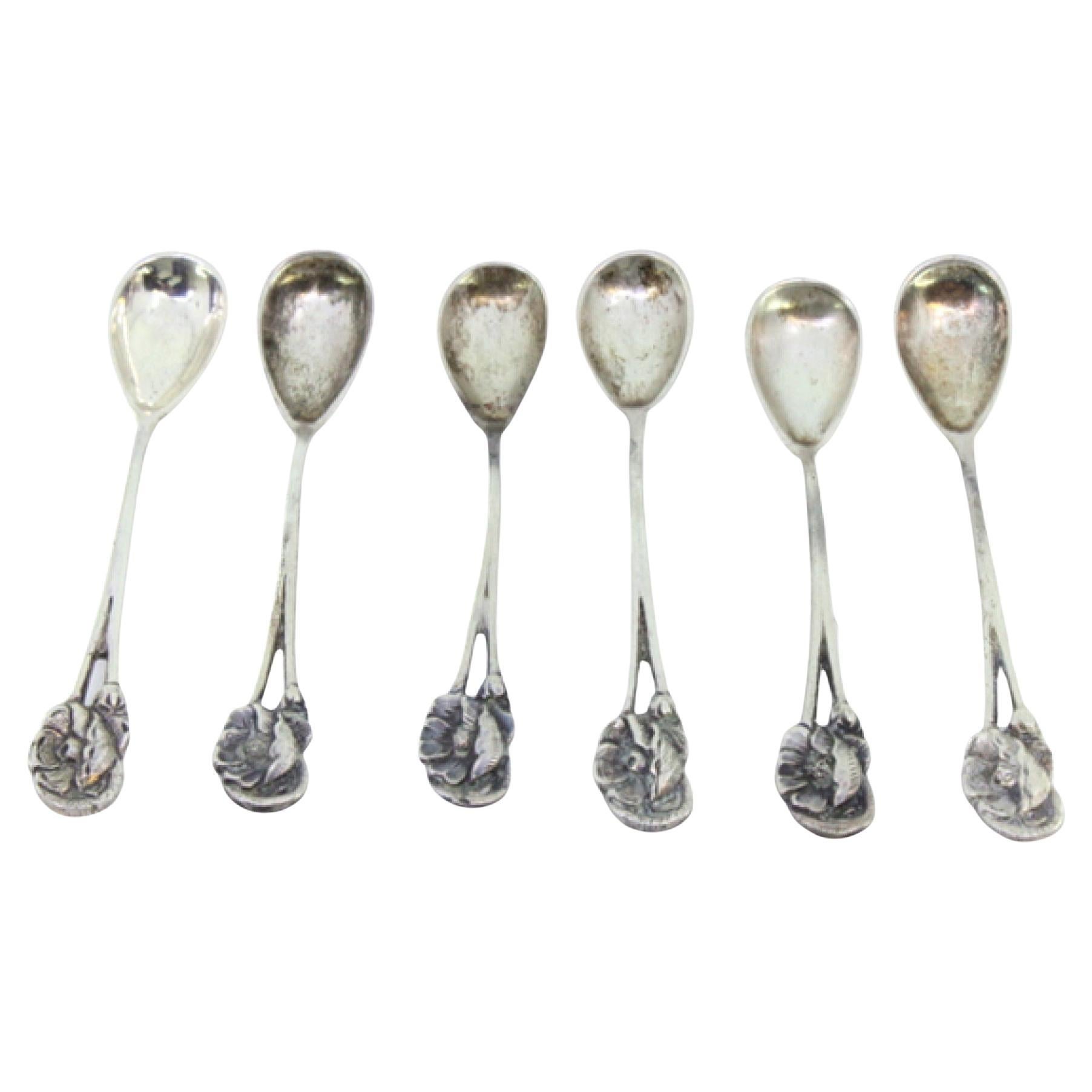 Set of six silver teaspoons with reliefs and flowers on the handles