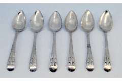 Set of six silver teaspoons with reliefs on the handles