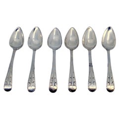 Set of six silver teaspoons with reliefs on the handles