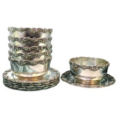 Set of six silver washbasins and plates with raised edges