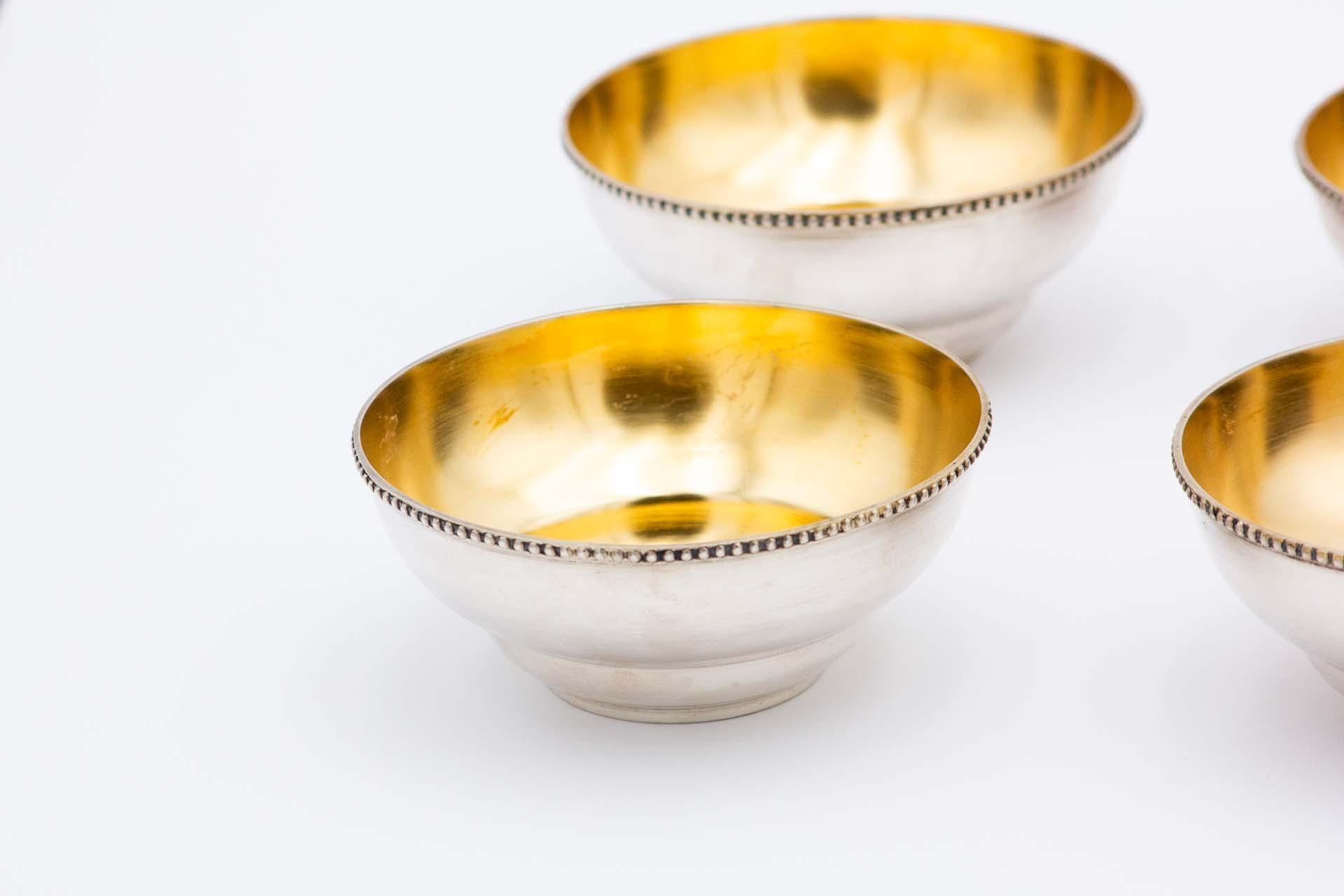 Description: Set of six silver washbasins with relief on the edges and gilded interior. Metal: Silver. Origin: Portuguese. Mark: standing eagle. Weight: 980.68 grams. Dimensions: 12.6cmx5.5cm. Content: 833/1000. Assay Mark: Yes, between 1938 and