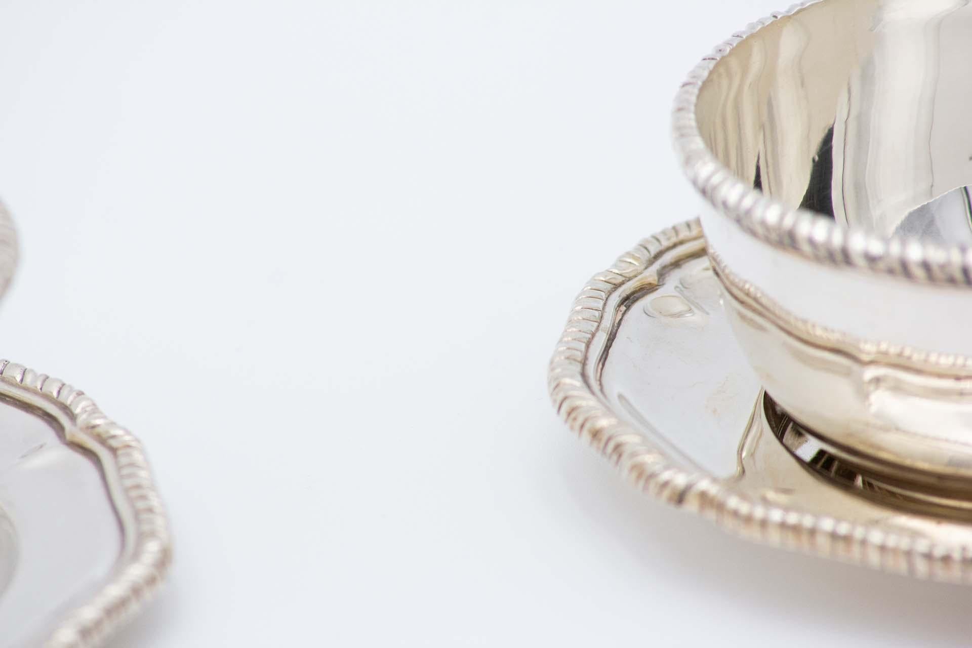 Description: Set of six silver wash basins with plates with rope-shaped edges. Metal: Silver. Origin: Portuguese. Mark: Standing Eagle - I Title. Weight: 1568.63 grams. Dimensions: Saucer 12.7cmx1.4cm  . Content: 916/1000. Assay Mark: Yes, between