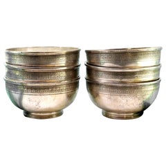 Set of six silver washbasins with engraved friezes on the surrounds