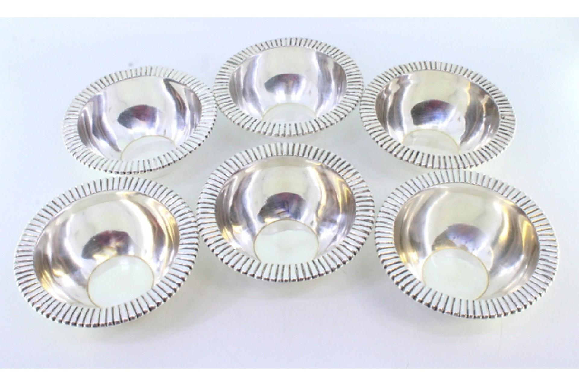 Description: Set of six silver wash basins with revealed edges. Metal: Silver. Origin: Portuguese. Mark: standing eagle. Weight: 728.09 grams (Set of six wash basins). Dimensions: 11.7cmx4.5cm. Content: 916/1000. Assay Mark: Yes, between 1938 and