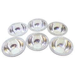 Set of six silver washbasins with raised edges