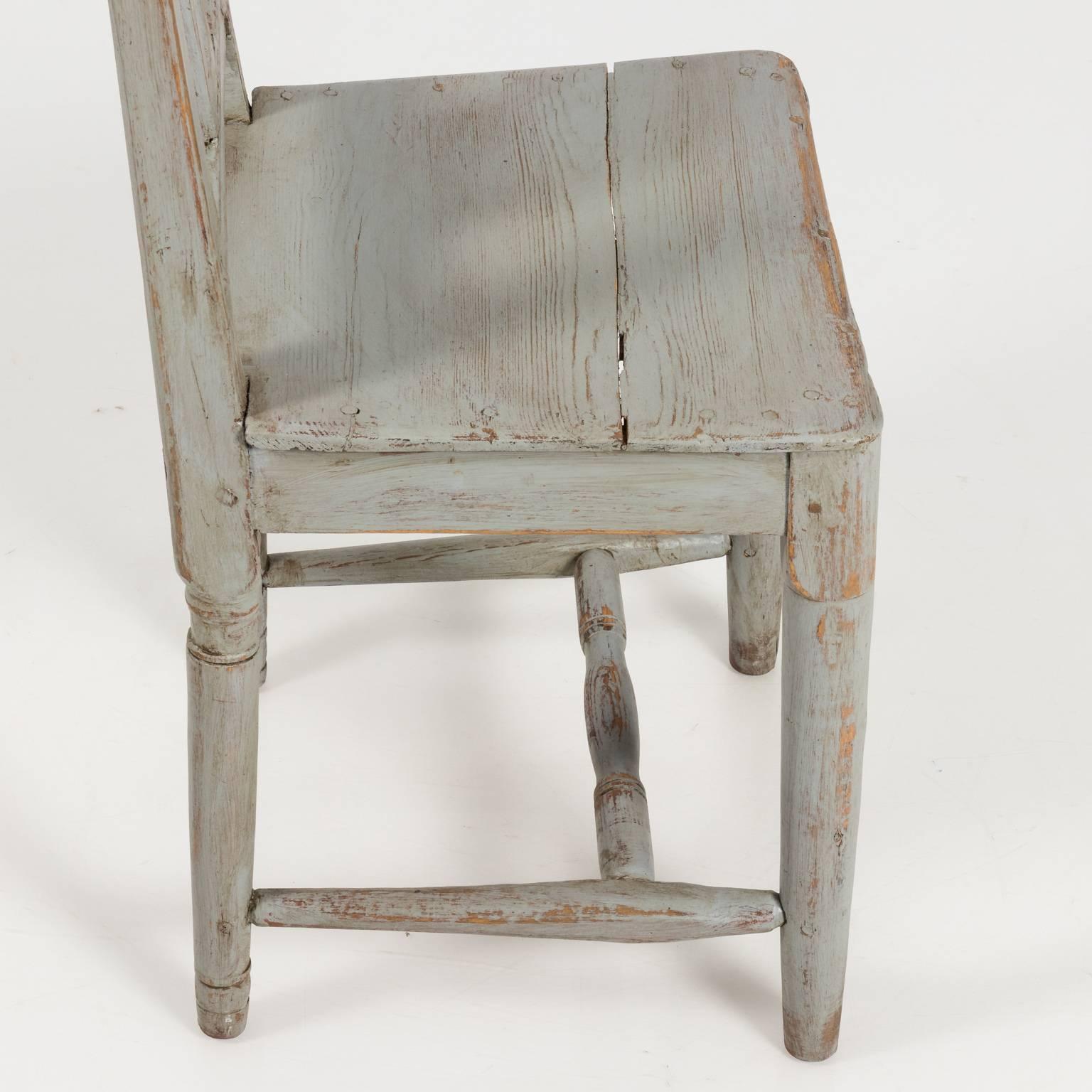 Set of six grey painted pinewood chairs that feature straight openwork packs, square seating, rounded ring turned legs, and an H-shaped cross stretcher, circa early 19th century. Please note that sizes of each chair vary according to construction