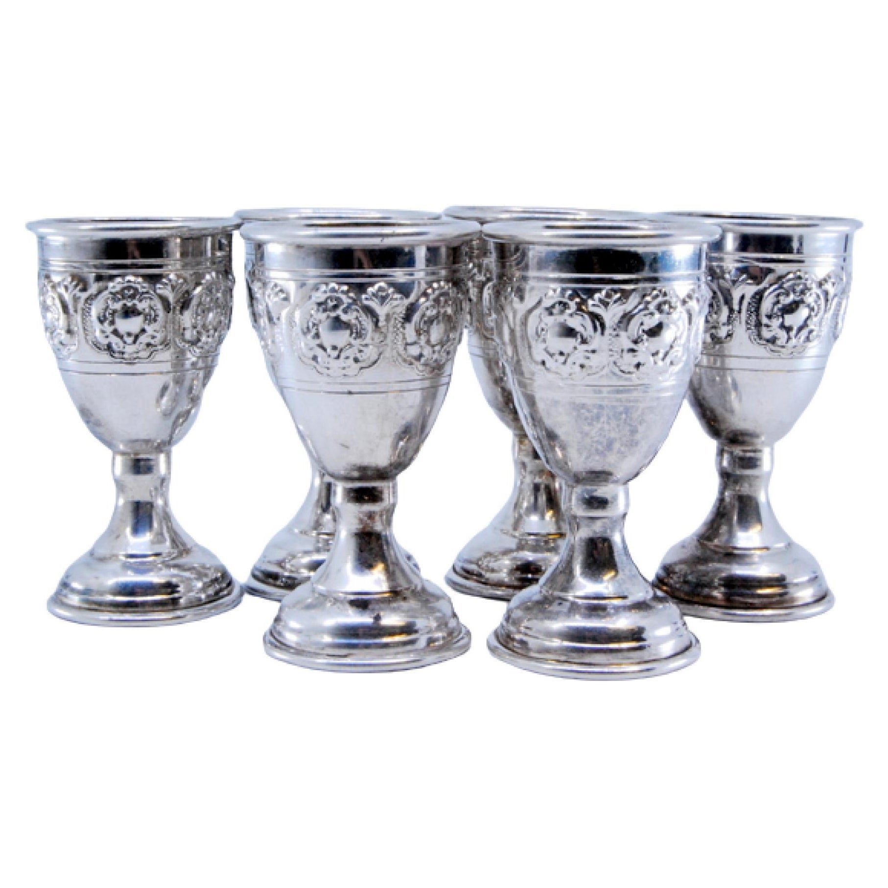 Set of six small silver goblets with reliefs and a smooth base
