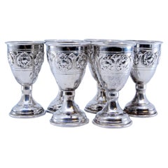Set of six small silver goblets with reliefs and a smooth base