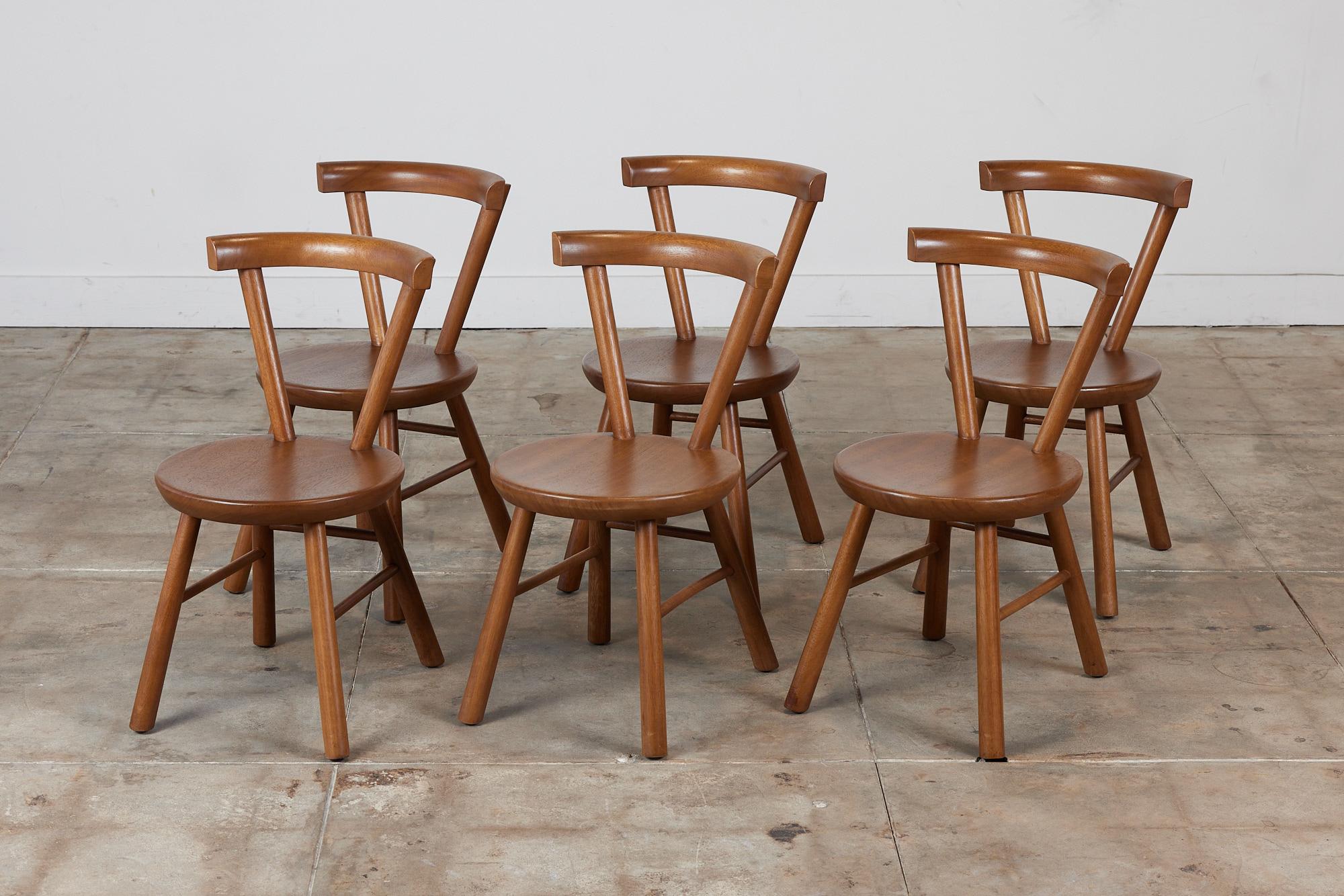 A minimalist set of six solid mahogany dining chairs c.1980s. The chairs are beautifully designed and crafted with a rounded backrest and splayed rounded legs. The minimalist design is comfortable and suits a variety of styles.

Dimensions: 16.5